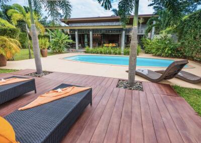 Outdoor area with pool and lounge chairs