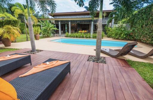 Outdoor area with pool and lounge chairs
