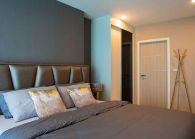 Modern bedroom with gray accents and decorative pillows