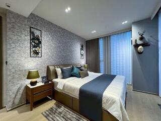 Modern bedroom with decorated walls and double bed