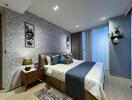 Modern bedroom with decorated walls and double bed