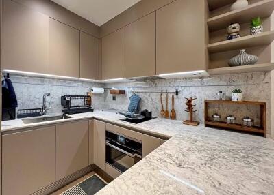 Modern kitchen with marble countertops and built-in appliances