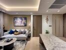 Modern living room with a sofa, decorative cushions, and wall art