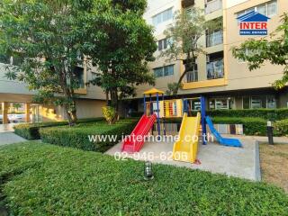 Outdoor area with playground in front of a residential building