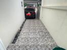 Covered garage with tiled flooring and parked car