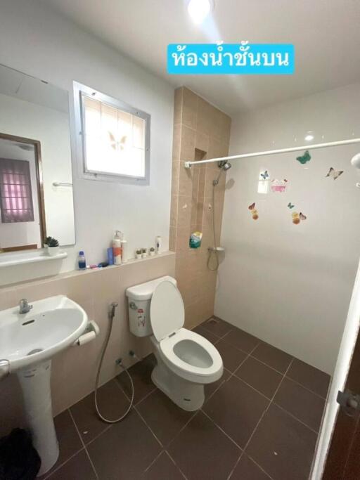 Bathroom with sink, toilet, shower area and window