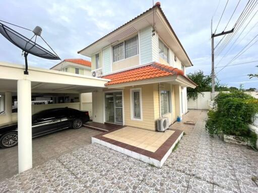 Exterior view of the house with carport and satellite dish