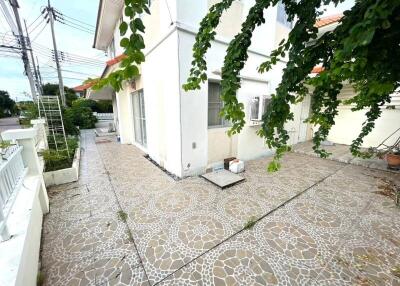 Outdoor area of a residential property with tiled flooring and greenery