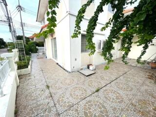 Outdoor area of a residential property with tiled flooring and greenery