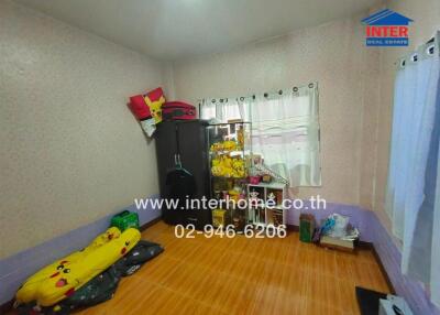 Cozy bedroom with hardwood flooring and cute plush toys