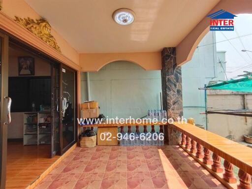 Covered terrace with sliding door and tiled floor