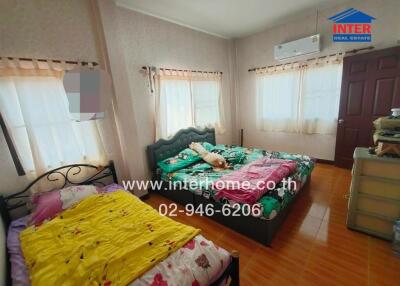 Bedroom with two beds and air conditioning