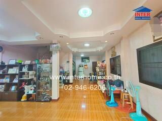 Spacious living room with ceiling lighting and wooden flooring.