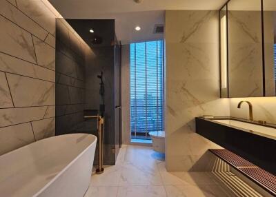 Luxurious modern bathroom with freestanding bathtub, walk-in shower, and dual sinks