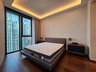 Modern bedroom with large windows and city view