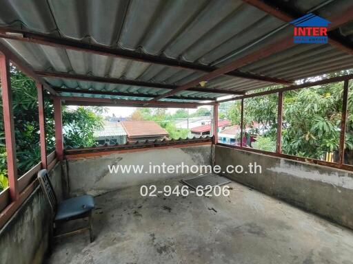 Outdoor area with roof covering, overlooking neighborhood houses and greenery