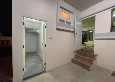 Entryway with open door, stairs, and adjacent bathroom