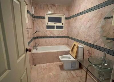 Spacious bathroom with bathtub and modern fixtures