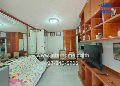 Spacious living room with wooden furniture and large mirror