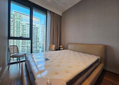 Spacious bedroom with large bed and city view