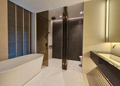 Modern bathroom with a freestanding bathtub and glass-enclosed shower