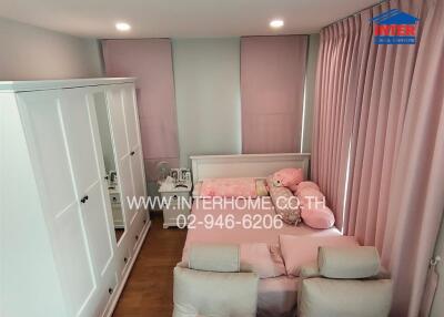 Bedroom with pink curtains and pink bedding