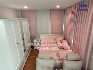 Bedroom with pink curtains and pink bedding