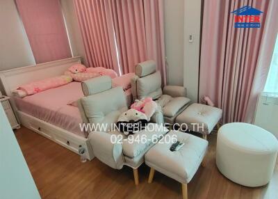 Spacious bedroom with comfortable seating and a large bed