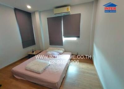 Bedroom with a bed, window blinds, and air conditioning unit