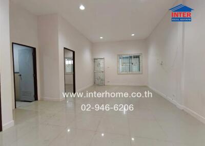 Spacious main living area with tiled floors and large windows