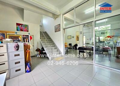 Office space with stairs and glass-enclosed rooms