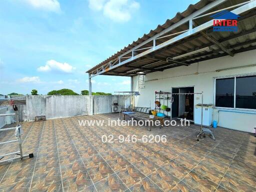 Spacious rooftop terrace with tiled flooring and covered section