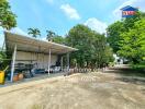 Outdoor area with canopy and tropical trees