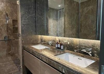 Modern bathroom with double sinks and glass-enclosed shower