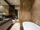 Luxurious modern bathroom with marble tiles, double sinks, bathtub, and large mirror
