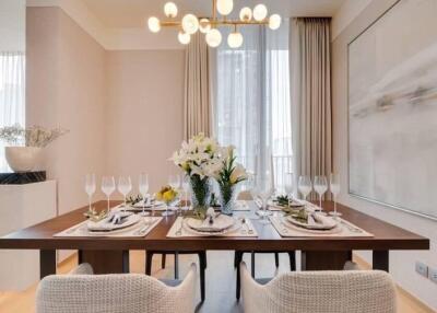 Well-decorated dining room with a modern chandelier and elegant table setting