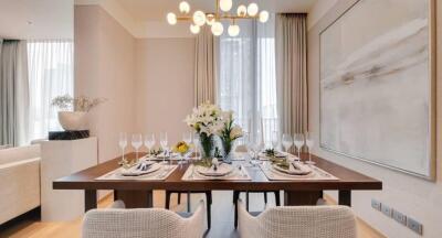 Well-decorated dining room with a modern chandelier and elegant table setting