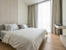 Modern bedroom with a large window and a bed with white bedding