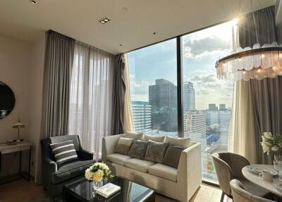 Modern living room with large window, city view, and dining area
