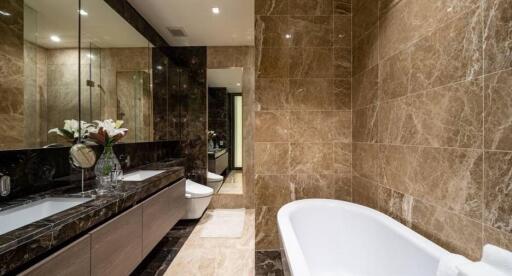 Modern bathroom with marble tiles and a bathtub
