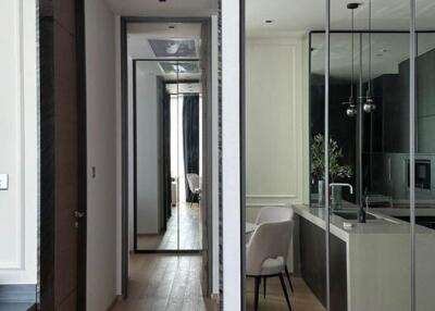 Modern kitchen with dining area facing hallway and reflective mirror