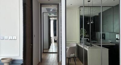 Modern kitchen with dining area facing hallway and reflective mirror