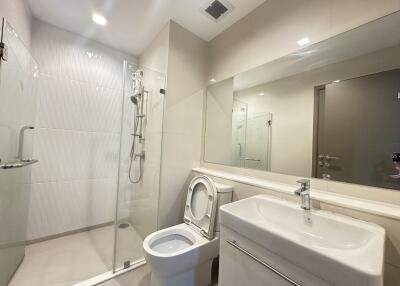 Modern bathroom with glass shower and large mirror