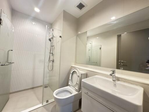 Modern bathroom with glass shower and large mirror