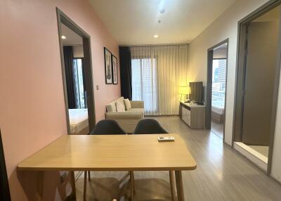 Living area with dining table, couch, and TV