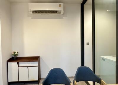 Small dining area with air conditioner and minimalist decor