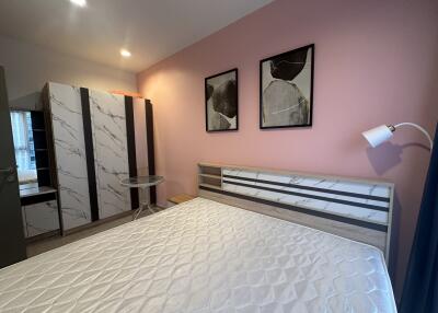 Well-lit bedroom with double bed and wardrobe