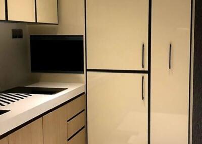 Modern kitchen with cream cabinets and black accents