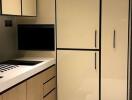 Modern kitchen with cream cabinets and black accents