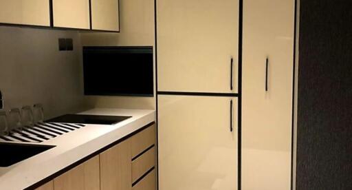 Modern kitchen with cream cabinets and black accents